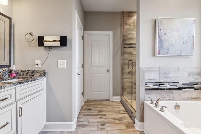 bathroom with vanity, hardwood / wood-style floors, and separate shower and tub