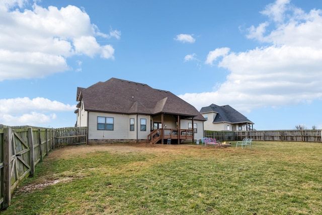 back of house with a wooden deck and a yard