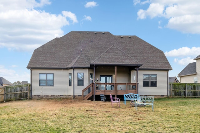 back of property with a deck and a lawn