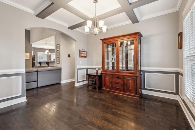 dining area featuring dark hardwood / wood-style flooring, coffered ceiling, and a chandelier