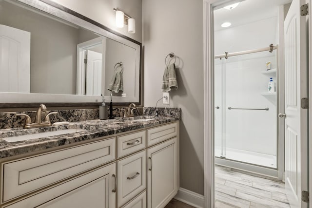 bathroom with vanity and a shower with door