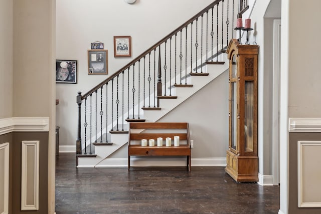 stairs featuring hardwood / wood-style floors