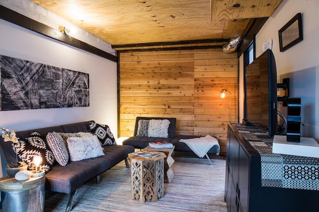 living room with wooden walls and wooden ceiling