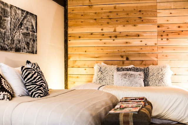 bedroom featuring wood walls