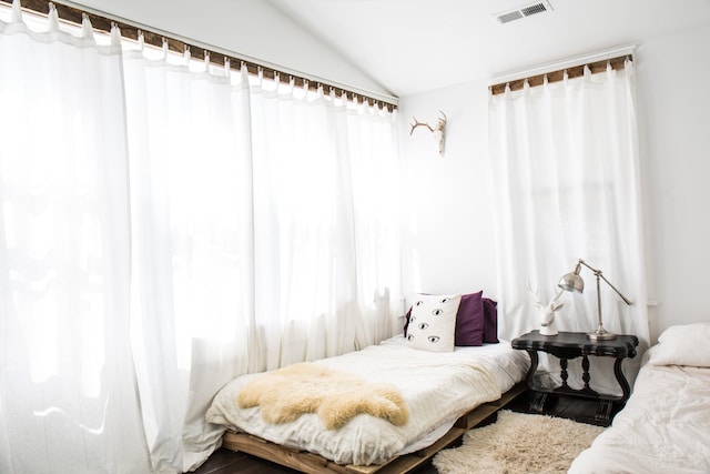 bedroom featuring lofted ceiling and hardwood / wood-style floors