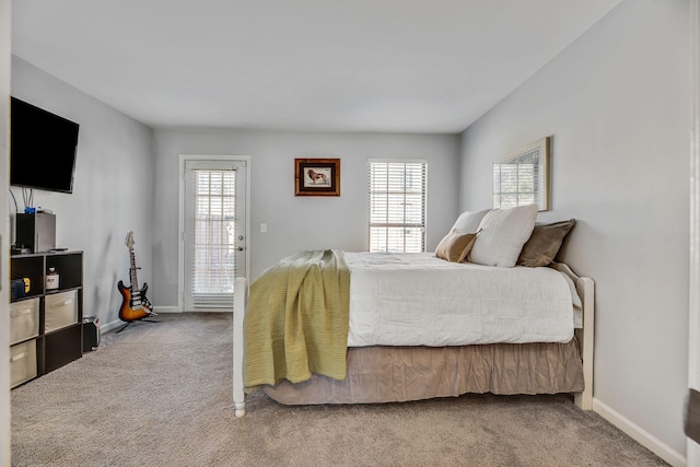 carpeted bedroom featuring multiple windows