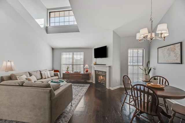 living room featuring an inviting chandelier, plenty of natural light, high vaulted ceiling, and dark hardwood / wood-style floors