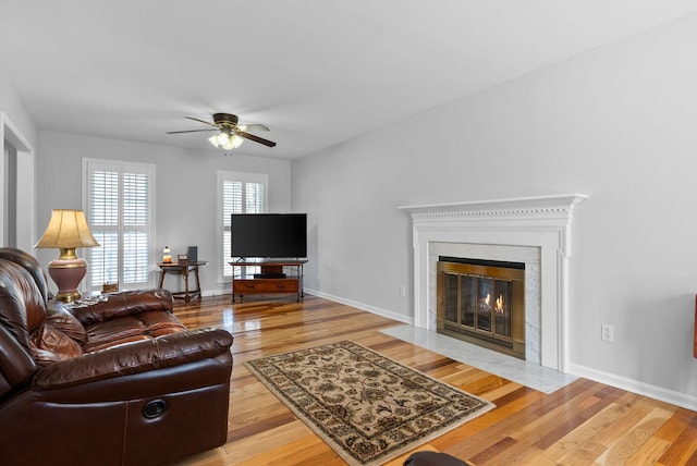 living room with light hardwood / wood-style floors and ceiling fan