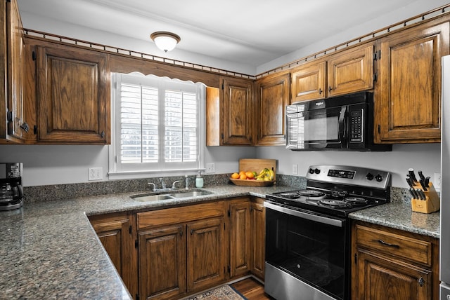 kitchen featuring electric stove and sink