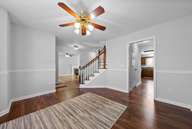 interior space with dark wood-type flooring and ceiling fan