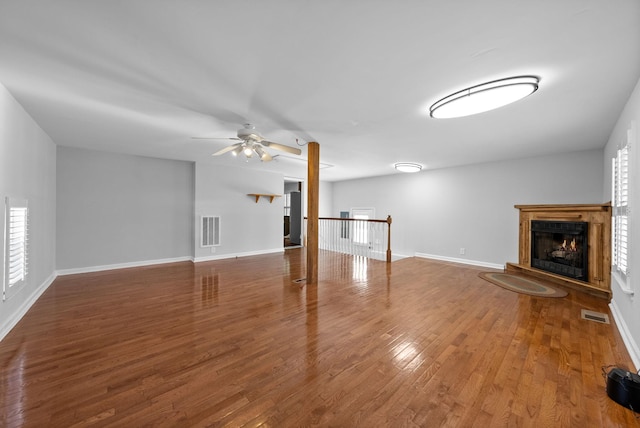 unfurnished living room featuring wood-type flooring and ceiling fan