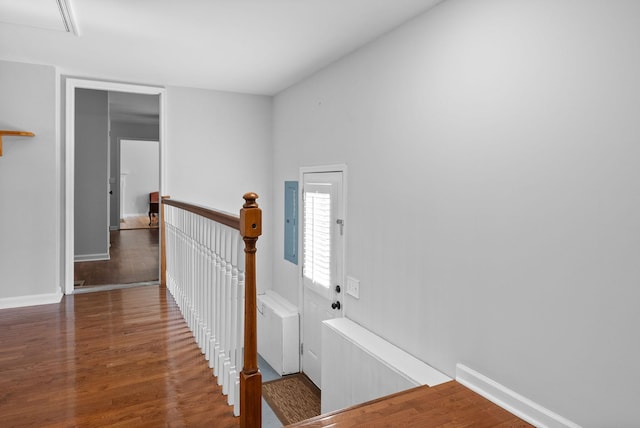 corridor with dark hardwood / wood-style floors and radiator heating unit