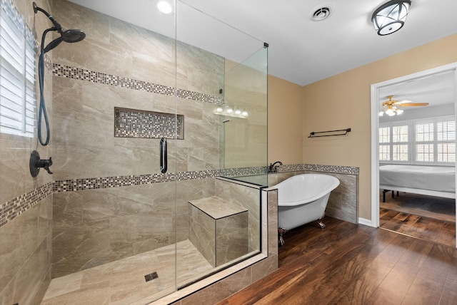 bathroom featuring ceiling fan, shower with separate bathtub, and hardwood / wood-style floors