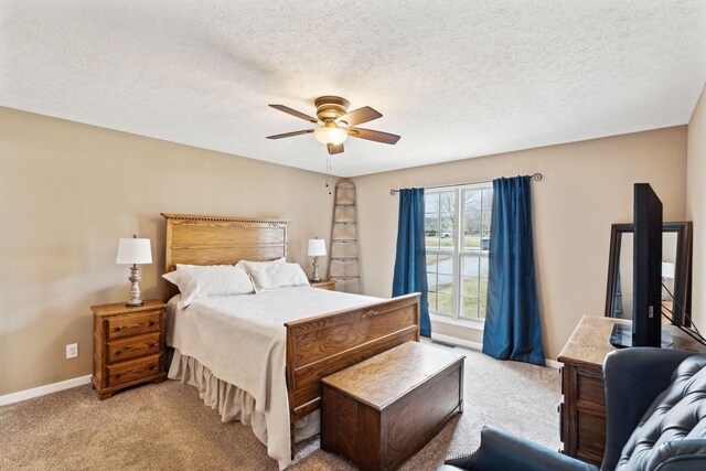 bedroom with light carpet, a textured ceiling, and ceiling fan