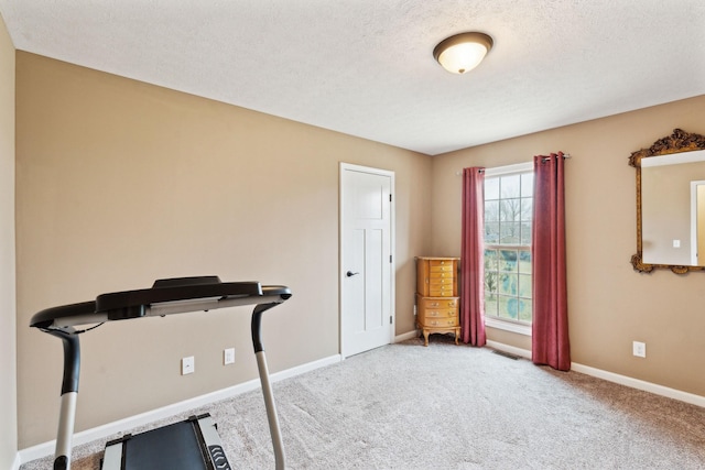 exercise area with a textured ceiling and carpet