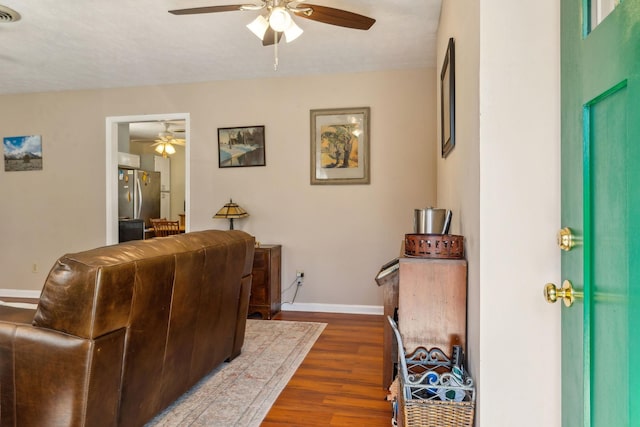 living room featuring hardwood / wood-style flooring and ceiling fan