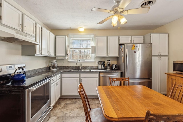 kitchen featuring white cabinetry, appliances with stainless steel finishes, sink, and a textured ceiling