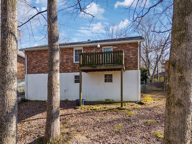 back of house featuring cooling unit and a balcony