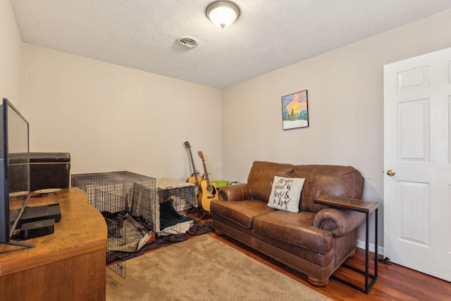 office area with hardwood / wood-style flooring and a textured ceiling