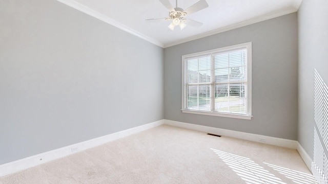 carpeted empty room featuring crown molding and ceiling fan