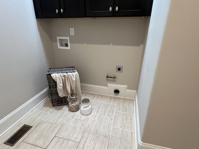 clothes washing area featuring electric dryer hookup, hookup for a washing machine, and cabinets