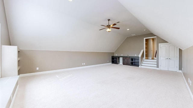 additional living space featuring vaulted ceiling, carpet floors, and ceiling fan