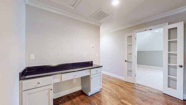 unfurnished office with crown molding, light wood-type flooring, and french doors