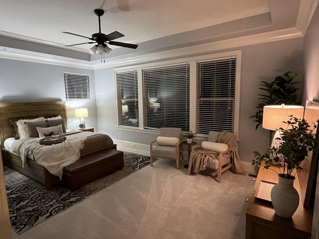 bedroom featuring a raised ceiling and ceiling fan