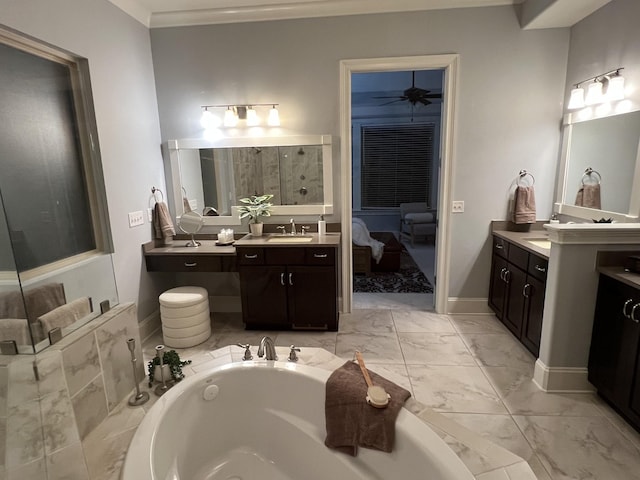 bathroom with a washtub, vanity, and ceiling fan