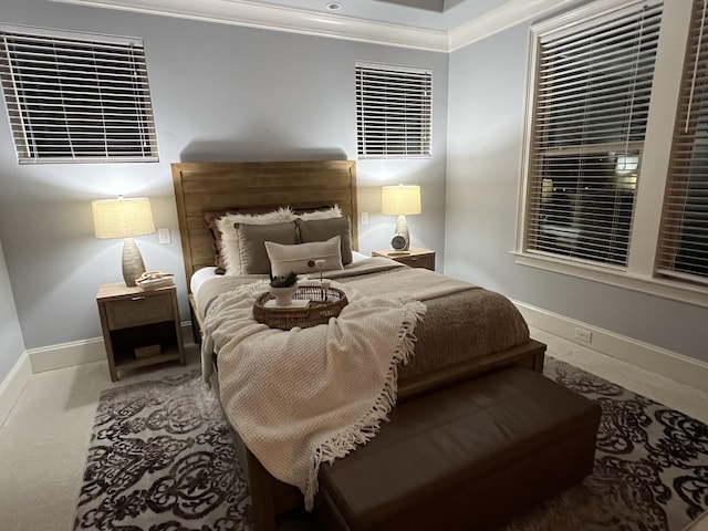 bedroom with crown molding and carpet floors