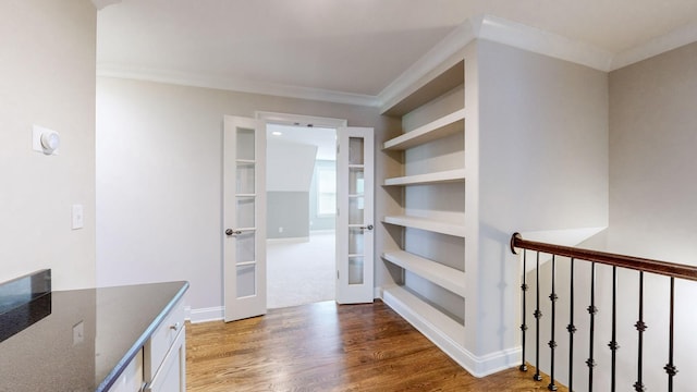 interior space featuring hardwood / wood-style flooring, crown molding, and french doors