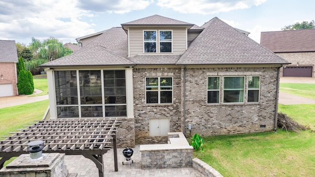 rear view of house with a yard and a sunroom