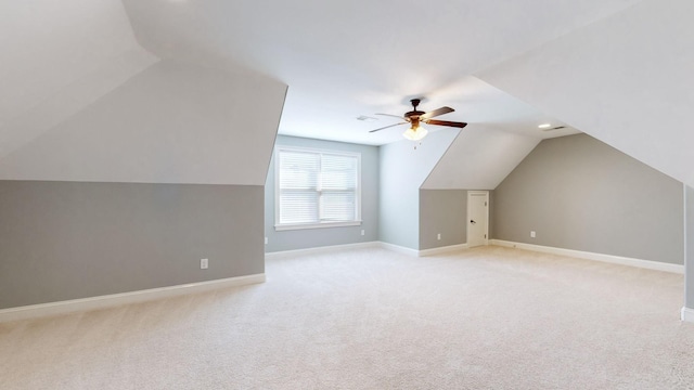 bonus room with ceiling fan, lofted ceiling, and light carpet