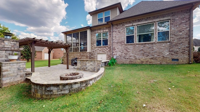 rear view of property featuring a fire pit, a yard, a pergola, and a patio area