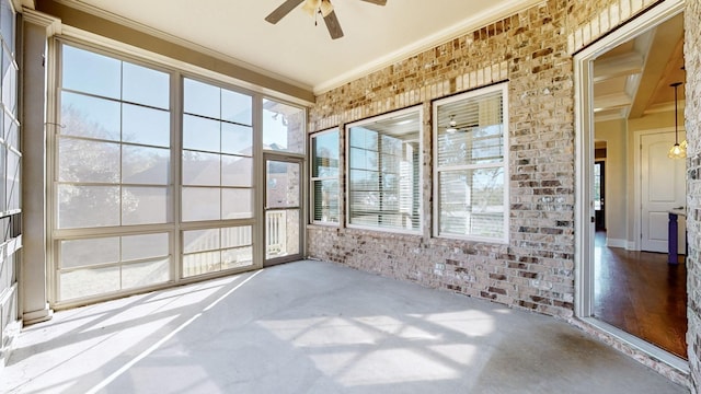 unfurnished sunroom featuring ceiling fan