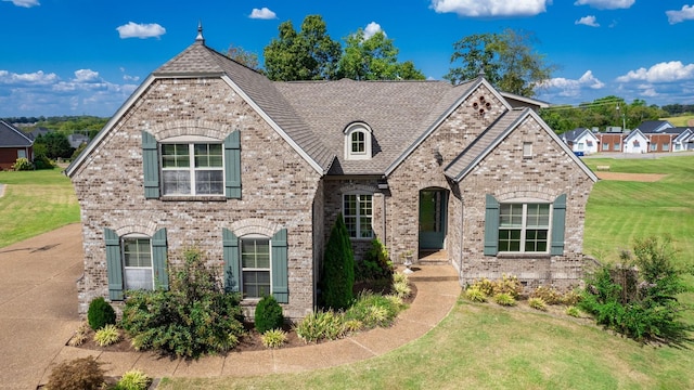 french provincial home featuring a front yard