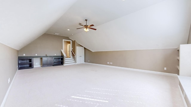 bonus room featuring ceiling fan, lofted ceiling, and carpet flooring