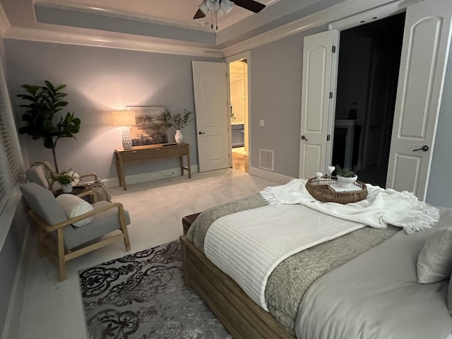 bedroom featuring ceiling fan, ornamental molding, carpet flooring, and a raised ceiling