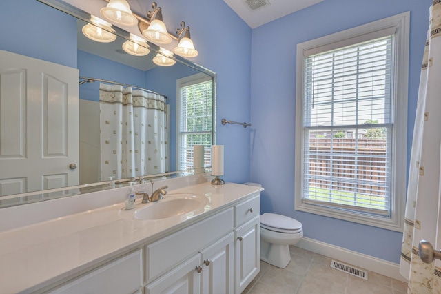 bathroom with a shower with curtain, tile patterned floors, toilet, and vanity