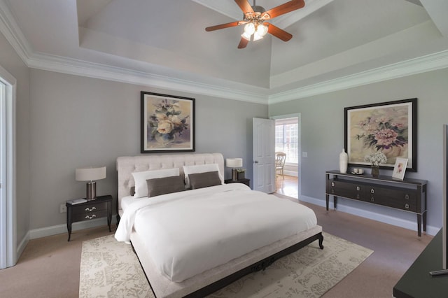 bedroom featuring carpet floors, ornamental molding, a raised ceiling, and ceiling fan