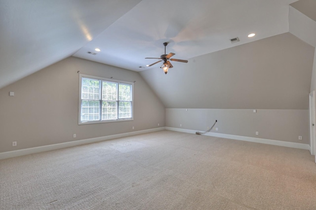 additional living space with lofted ceiling, light colored carpet, and ceiling fan