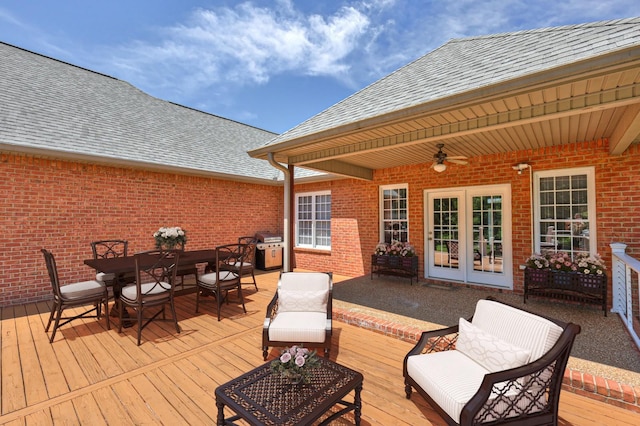 wooden terrace with ceiling fan and area for grilling