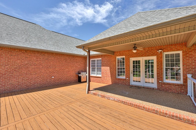 wooden terrace with grilling area and ceiling fan