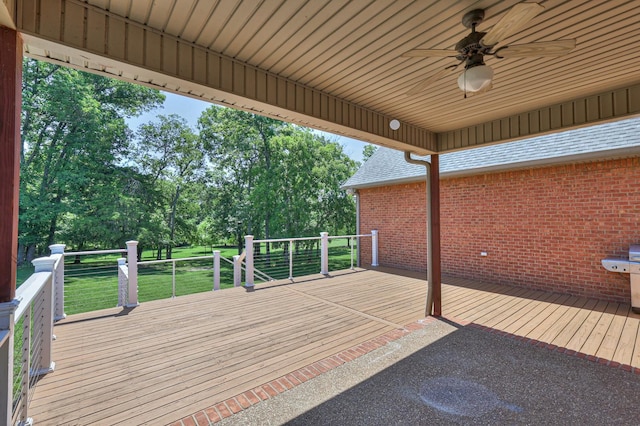 deck with ceiling fan and a lawn