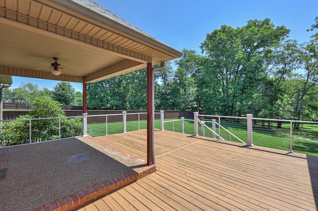 wooden deck featuring a yard and ceiling fan