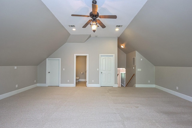 additional living space with lofted ceiling, light colored carpet, and ceiling fan