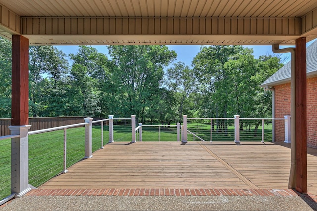 wooden terrace with a lawn