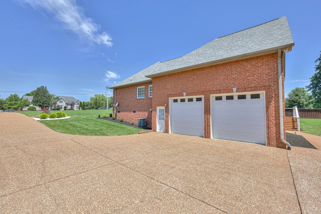 view of property exterior featuring cooling unit, a yard, and a garage