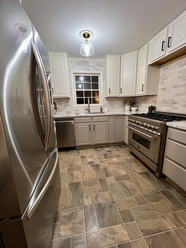 kitchen with sink, tasteful backsplash, crown molding, appliances with stainless steel finishes, and white cabinets