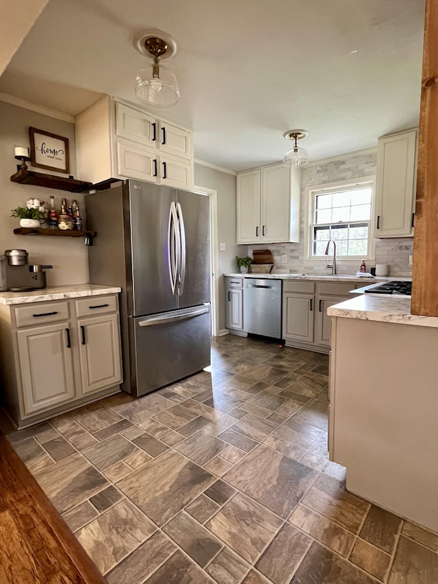 kitchen with appliances with stainless steel finishes, sink, decorative backsplash, hanging light fixtures, and ornamental molding